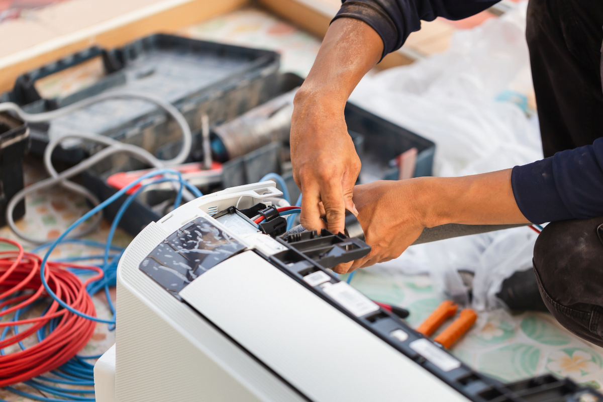 A technician doing HVAC maintenance.