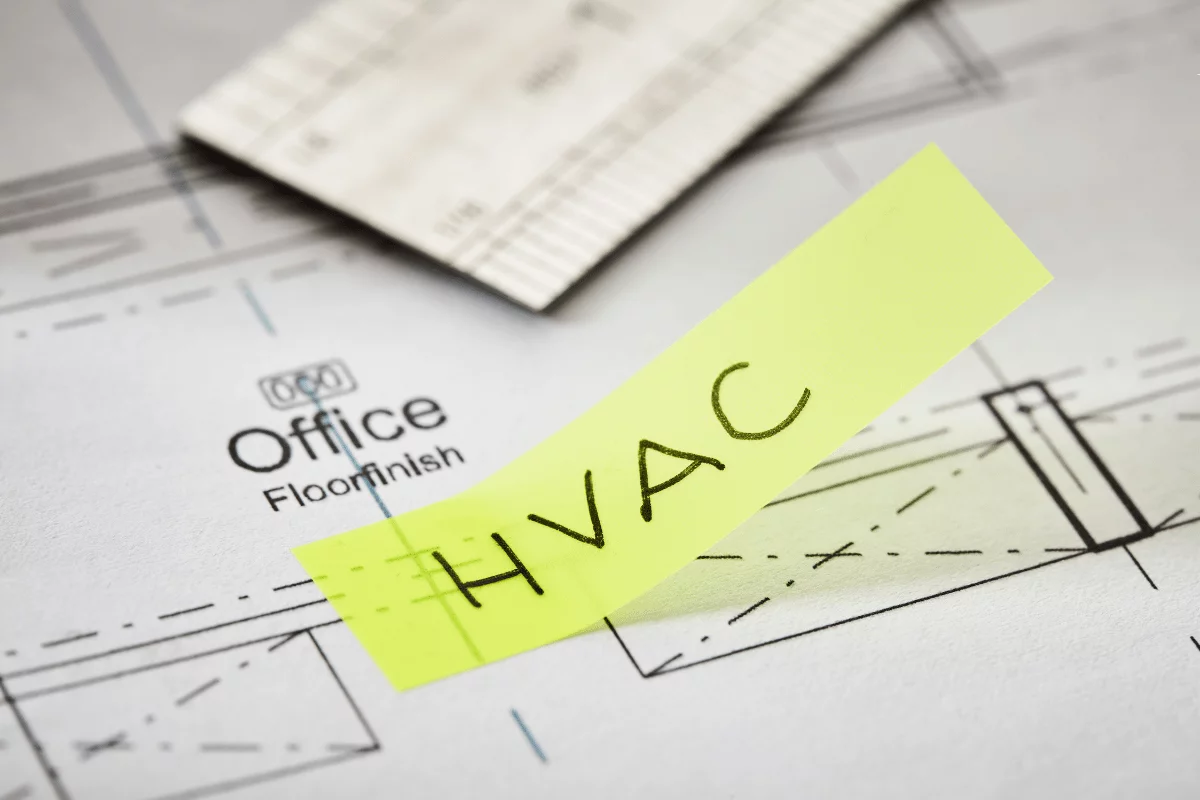 Macon HVAC Services 2 A blueprint of an office space with a piece of paper that has "HVAC" written on it.