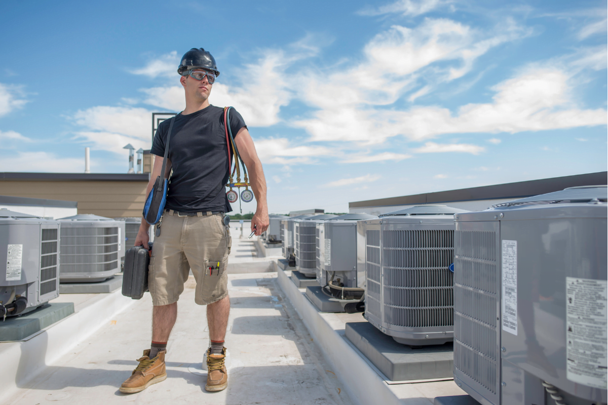 An HVAC expert from Kennesaw HVAC Services doing some inspection on the roof top.