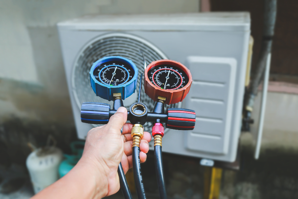 A technician from Milton HVAC Services doing some HVAC repair.