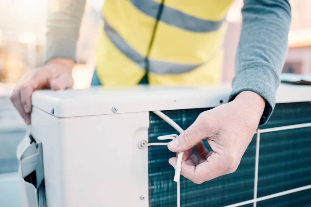 Stay Cool And Save Cash: The Top Benefits Of Commercial Preventative AC Maintenance 2 A technician conducting a preventative AC maintenance to avoid problems and ensure optimal comfort.